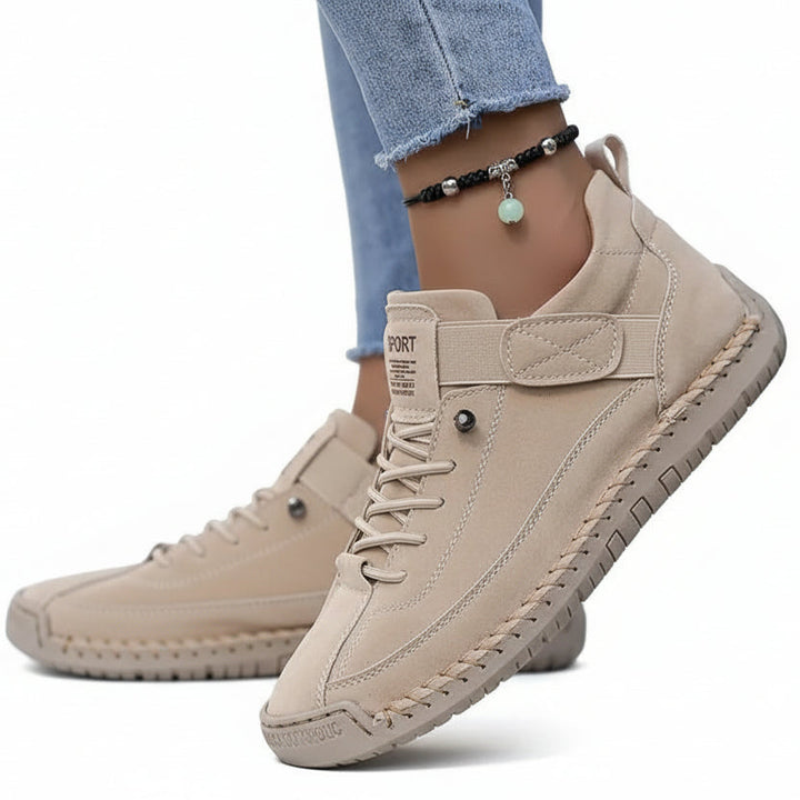 A pair of comfortable slip-on shoes in beige with elastic side panels and a wide toe box