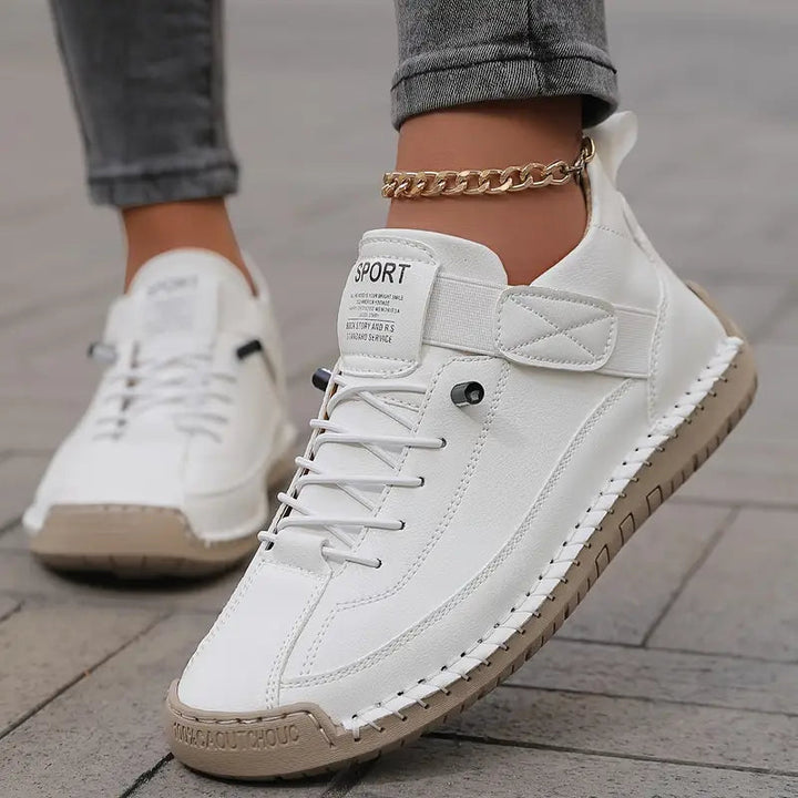 A pair of comfortable slip-on shoes in beige with elastic side panels and a wide toe box