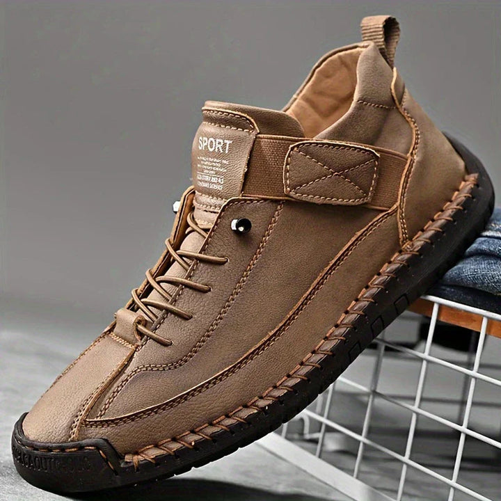 A pair of comfortable slip-on shoes in beige with elastic side panels and a wide toe box