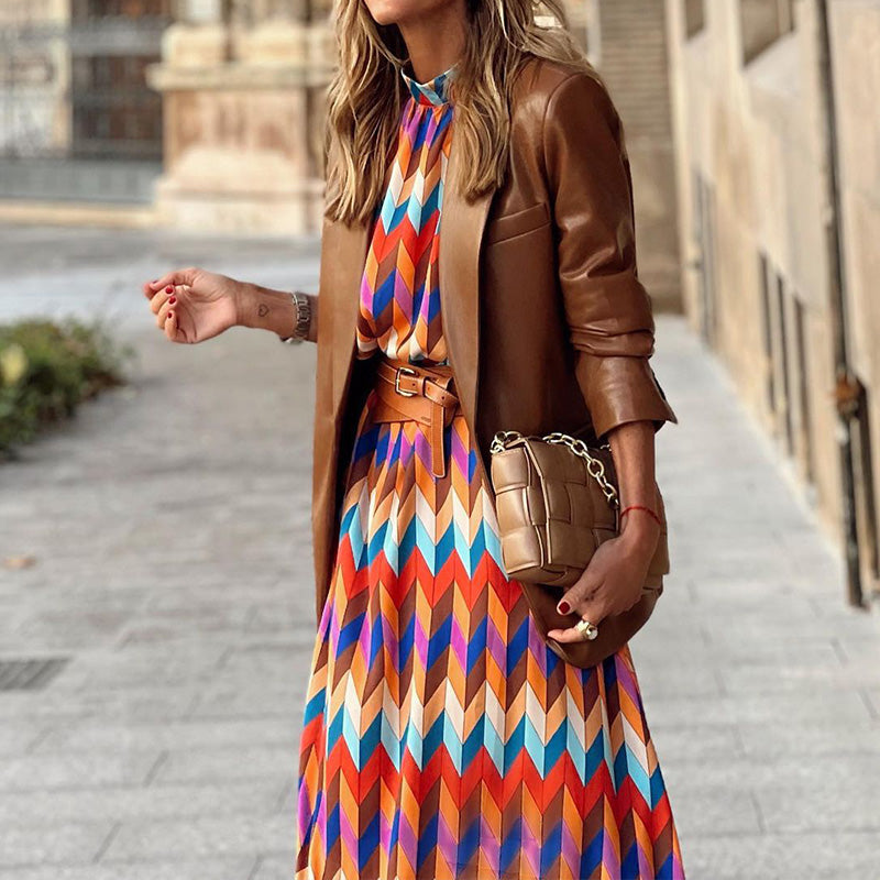 Woman in the Daisy geometric print maxi dress with a high neckline and puff sleeves, walking through a city street.