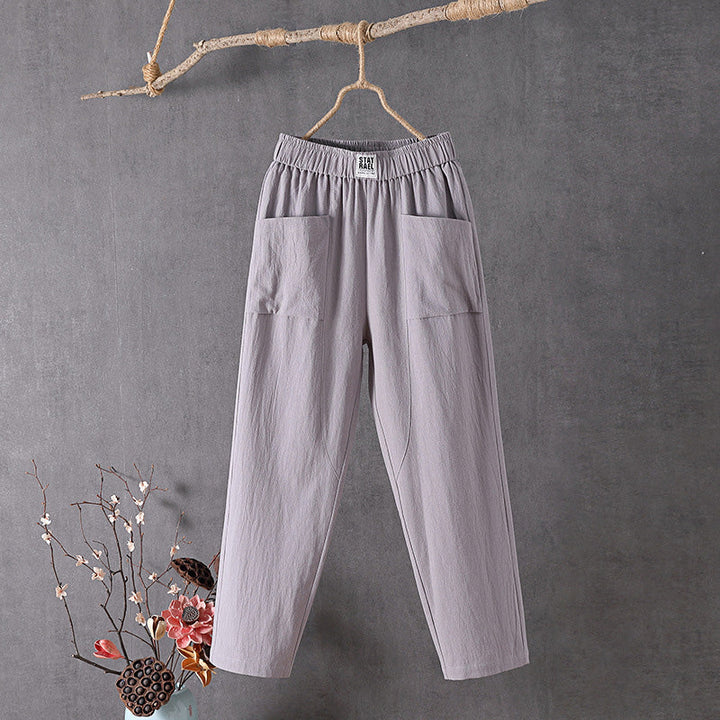 Relaxed tapered trousers with roomy front patch pockets and an elastic waist.