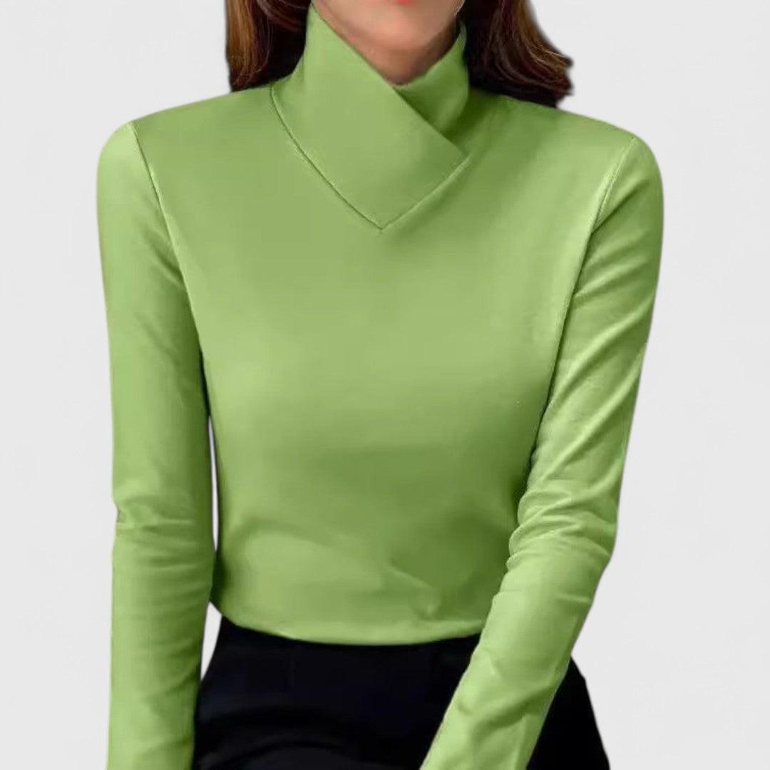 A woman wearing an elegant stand-collar jumper, slim and refined with a flattering line.