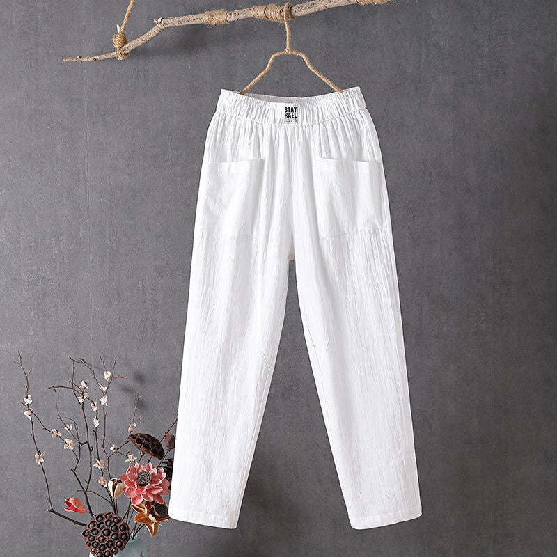 Relaxed tapered trousers with roomy front patch pockets and an elastic waist.