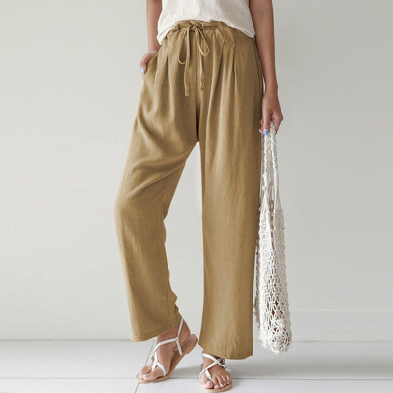 A woman walking outdoors in relaxed drawstring trousers with an easy, comfortable everyday look.