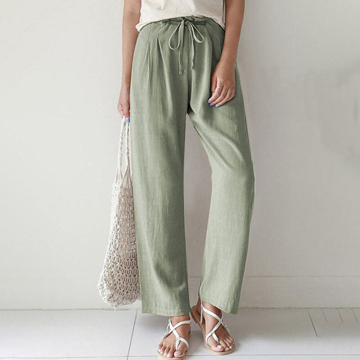 A woman walking outdoors in relaxed drawstring trousers with an easy, comfortable everyday look.