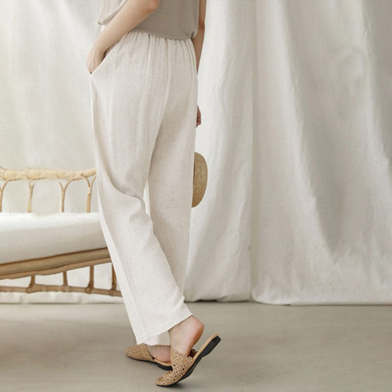 A woman walking outdoors in relaxed drawstring trousers with an easy, comfortable everyday look.