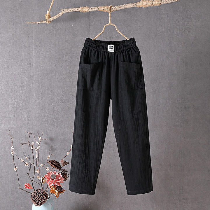 Relaxed tapered trousers with roomy front patch pockets and an elastic waist.