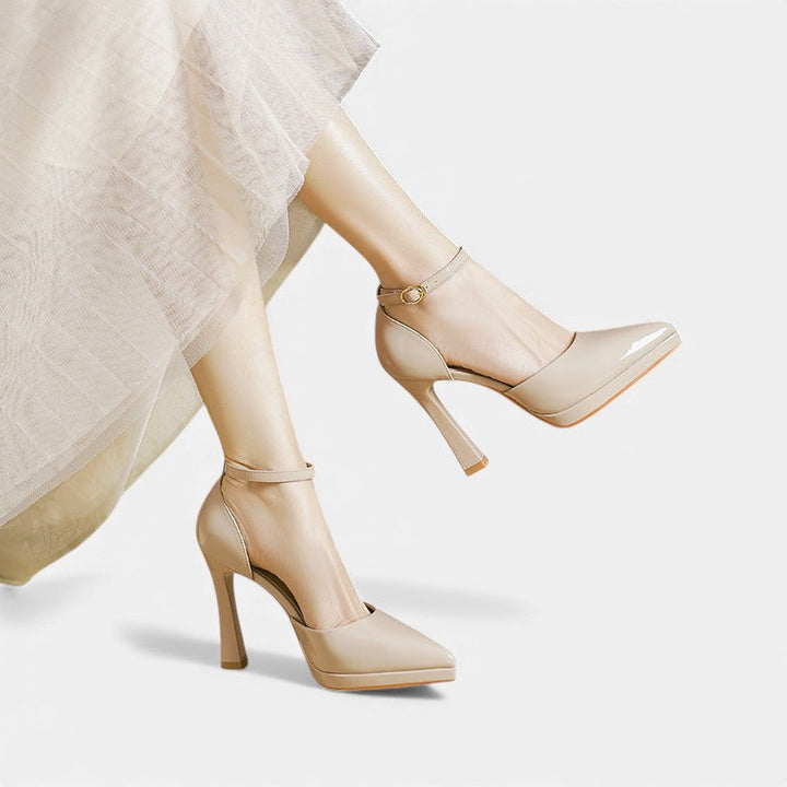 A woman in pointed ankle-strap pumps with a block heel, dressed for a day-to-night occasion.