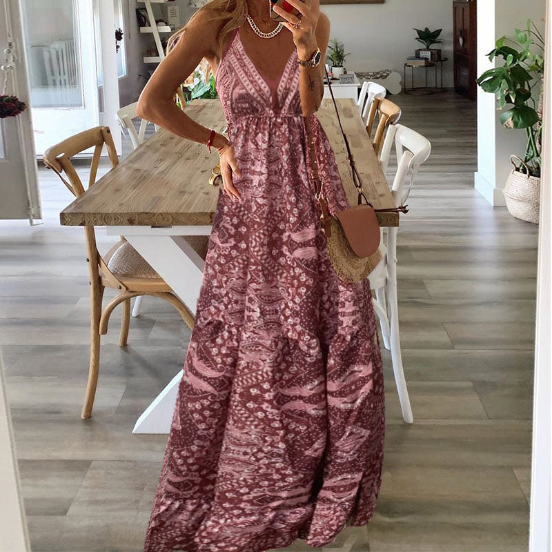 A woman wearing the Attracta sleeveless boho maxi dress with adjustable straps and a flowing tiered skirt.