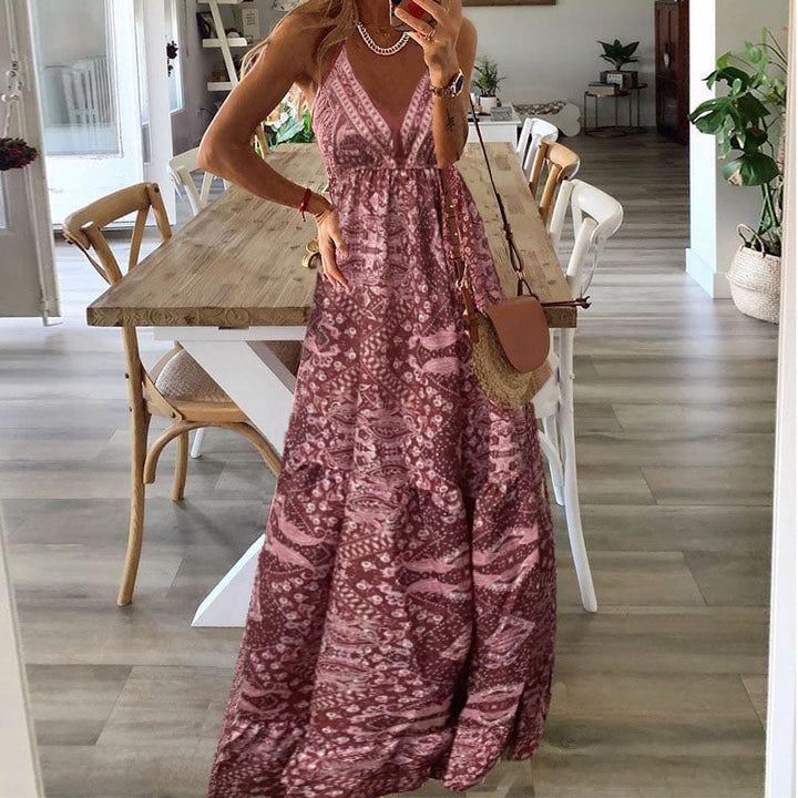 A woman wearing the Attracta sleeveless boho maxi dress with adjustable straps and a flowing tiered skirt.