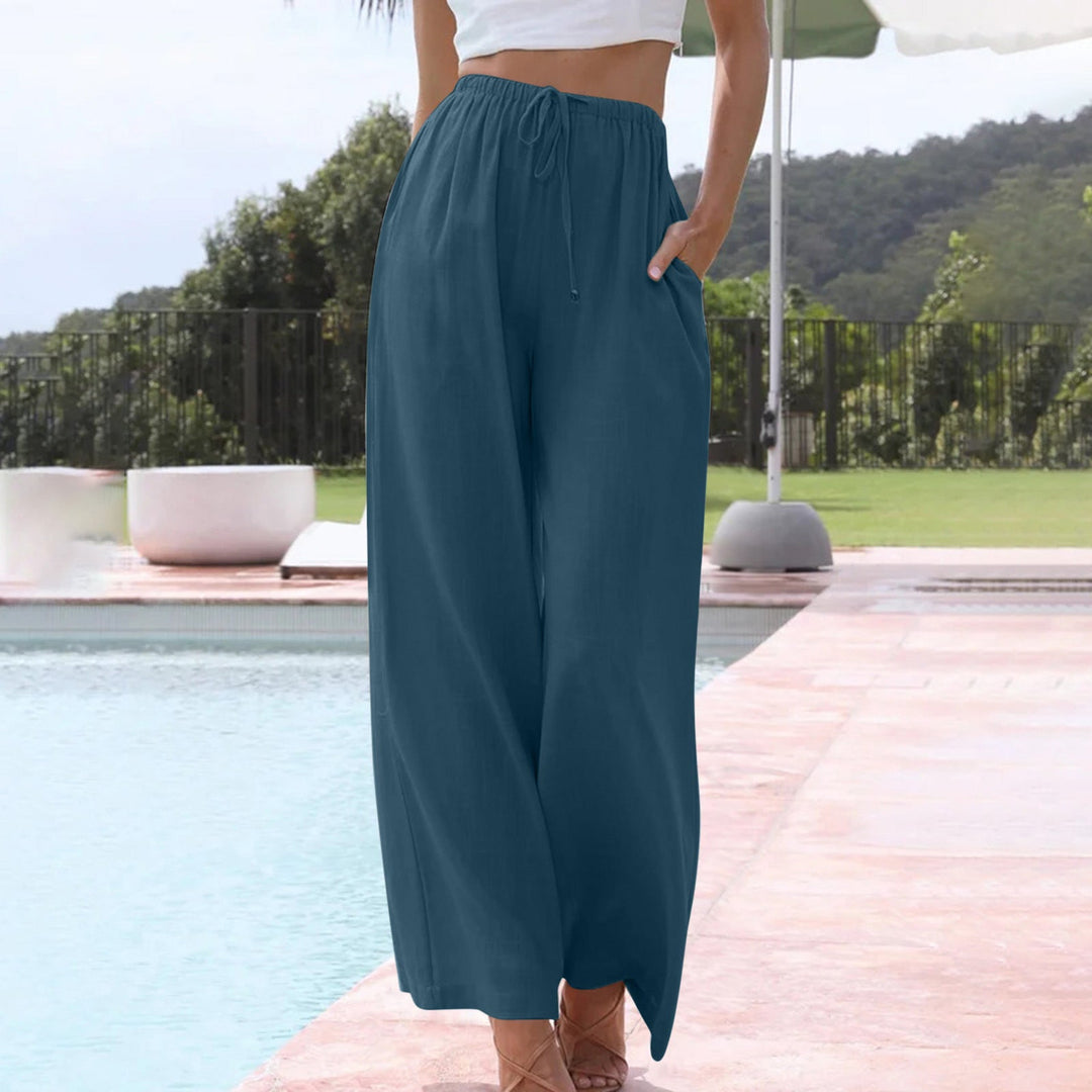 A woman in loose wide-leg summer trousers styled with a light top for an easy warm-weather look.