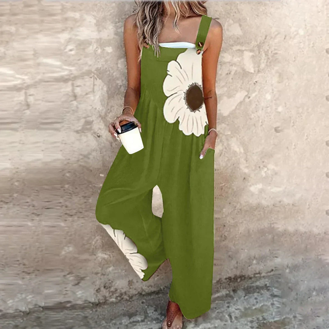 A woman wearing elegant black dungarees with a single large cream bloom and adjustable straps.