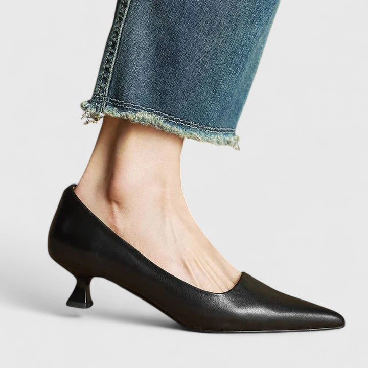 A woman in classic black pointed-toe comfort heels moving easily from office to evening.