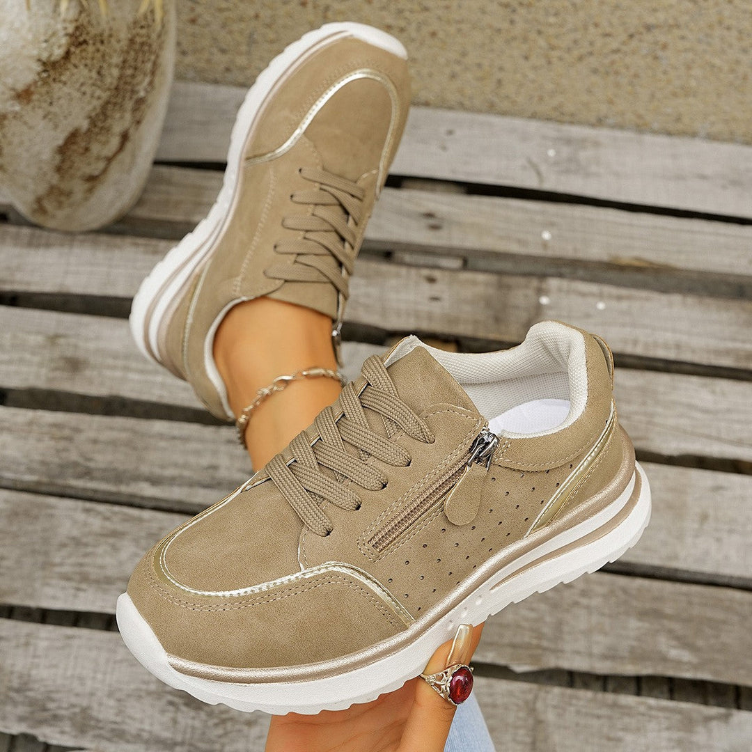 A woman standing comfortably in orthopaedic arch support trainers.