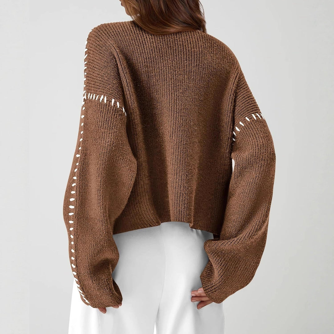A woman wearing an oversized mock-neck jumper with whipstitch detailing, cosy and stylish.