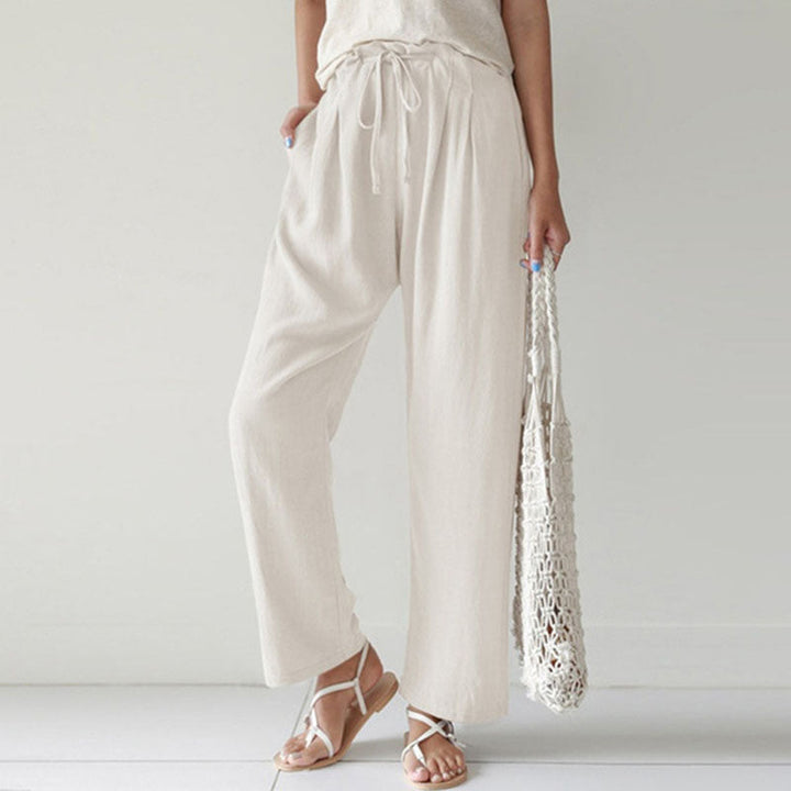 A woman walking outdoors in relaxed drawstring trousers with an easy, comfortable everyday look.