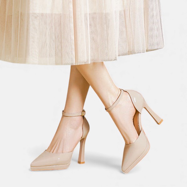 A woman in pointed ankle-strap pumps with a block heel, dressed for a day-to-night occasion.