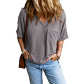 Grey relaxed V-neck top with wide sleeves and a small front pocket