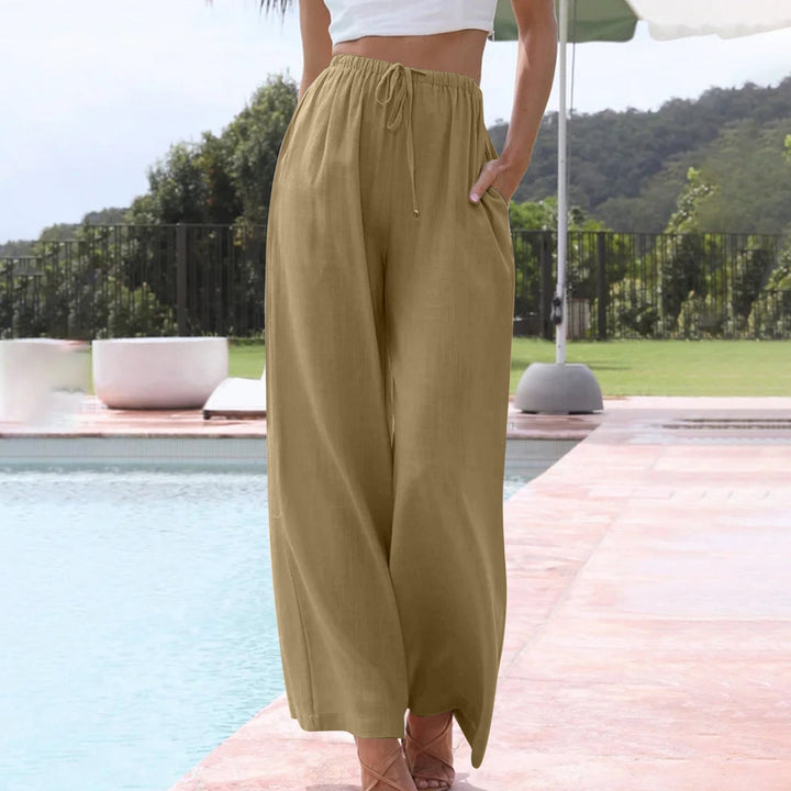A woman in loose wide-leg summer trousers styled with a light top for an easy warm-weather look.