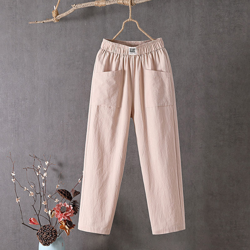 Relaxed tapered trousers with roomy front patch pockets and an elastic waist.
