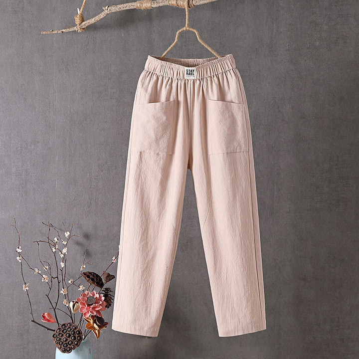 Relaxed tapered trousers with roomy front patch pockets and an elastic waist.