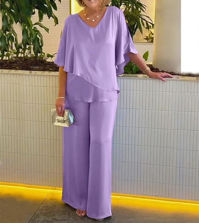 A woman wearing an asymmetric flowing top with matching wide-leg trousers.