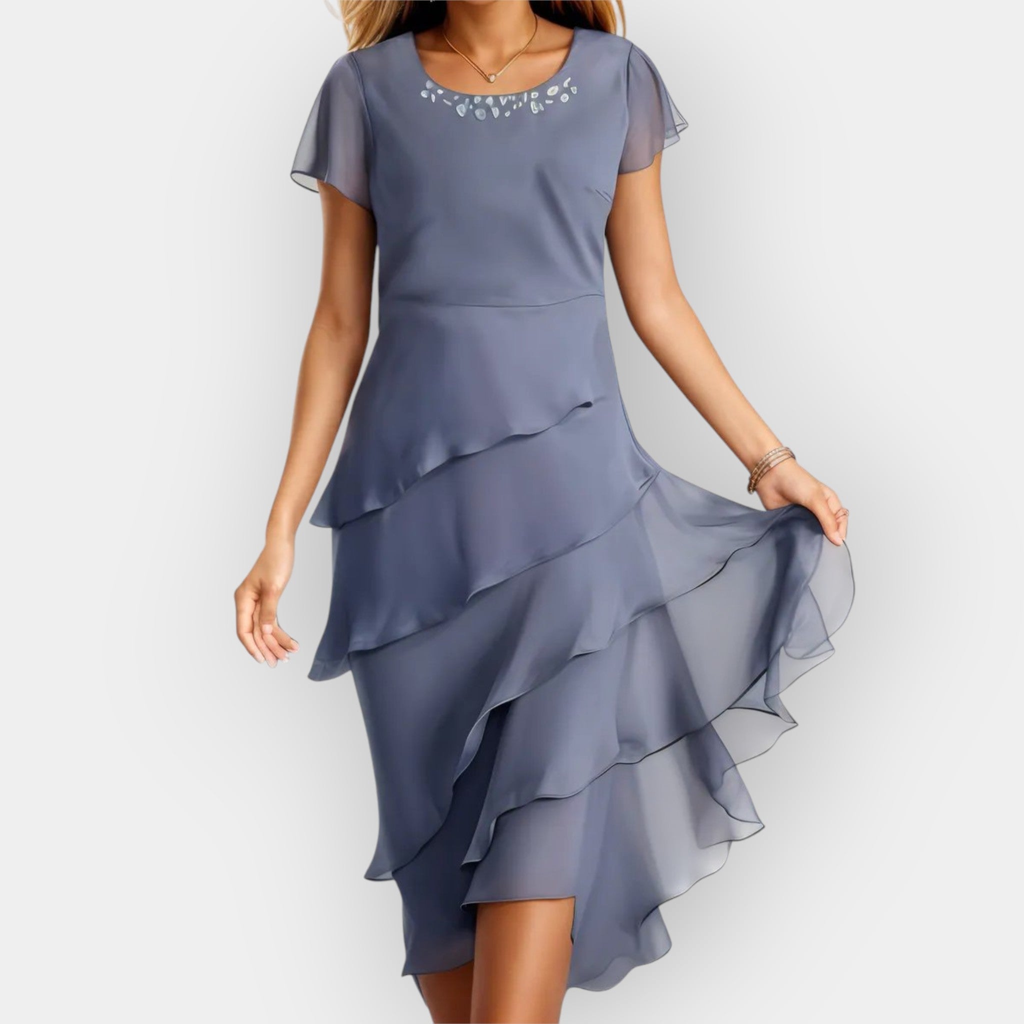 A floaty layered evening dress in light blue, styled for a summer occasion