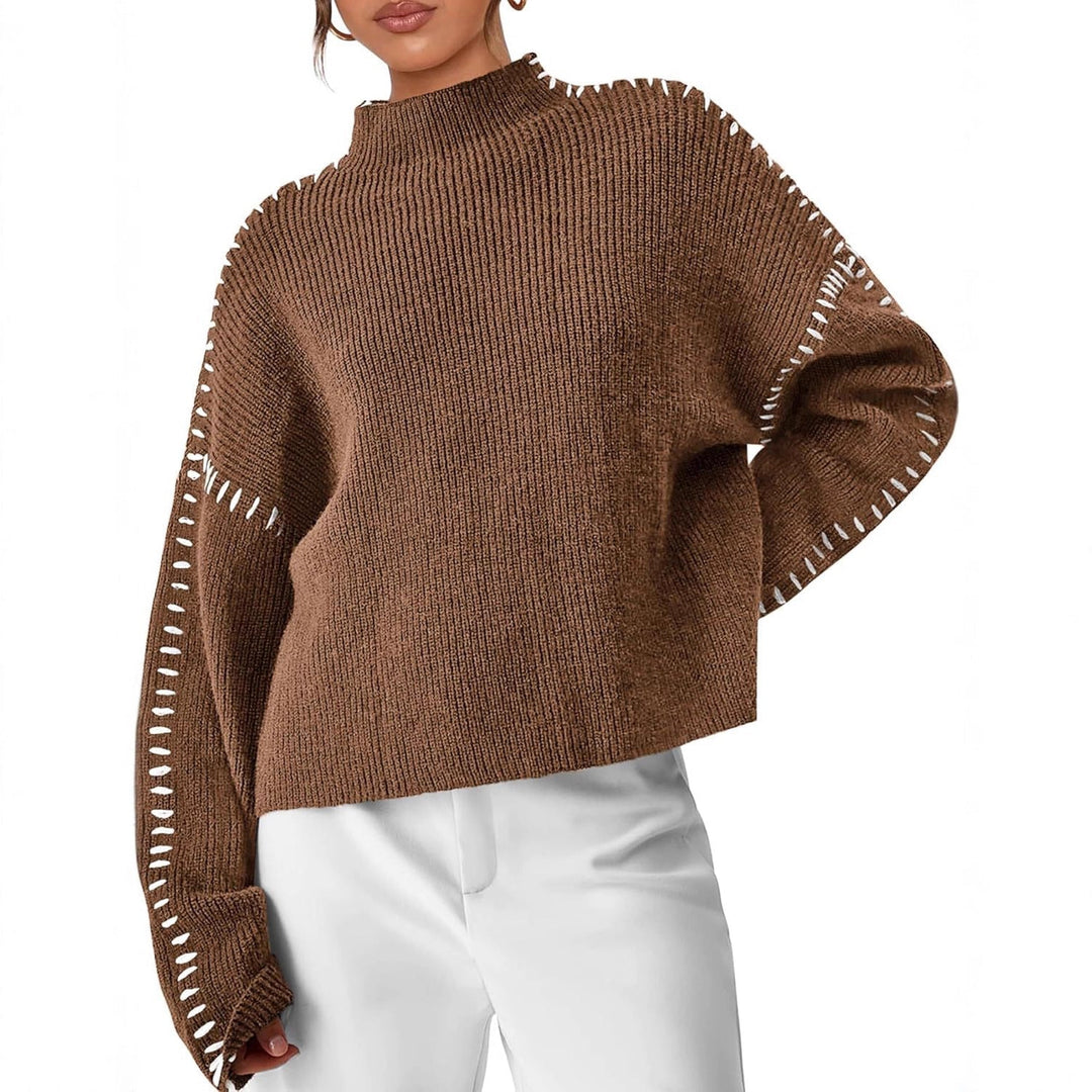 A woman wearing an oversized mock-neck jumper with whipstitch detailing, cosy and stylish.