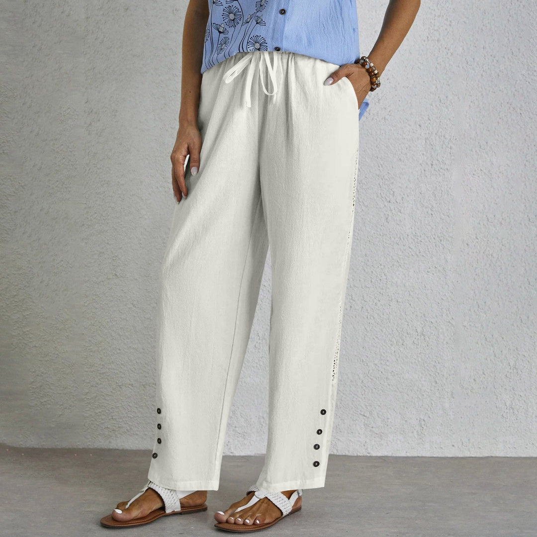 Woman wearing relaxed button-detail trousers with a simple top, out for the day.