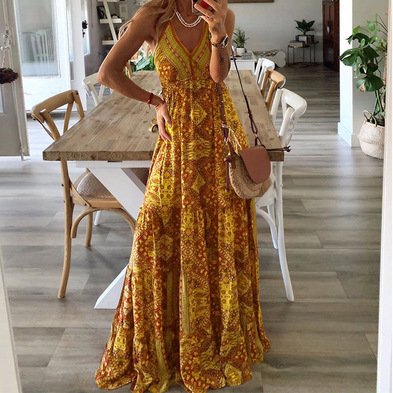 A woman wearing the Attracta sleeveless boho maxi dress with adjustable straps and a flowing tiered skirt.
