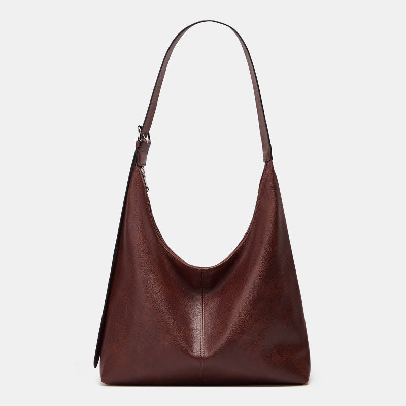 Oversized plain black crossbody bag with a wide shoulder strap