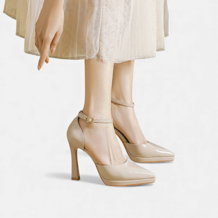 A woman in pointed ankle-strap pumps with a block heel, dressed for a day-to-night occasion.