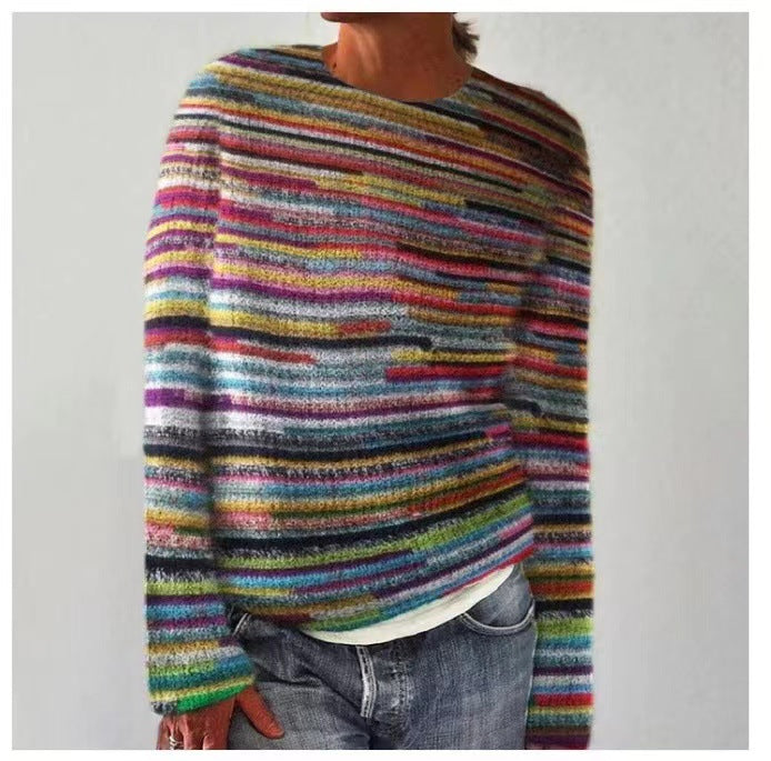 A woman wearing a soft jumper covered in bright multicoloured horizontal stripes, relaxed and warm.