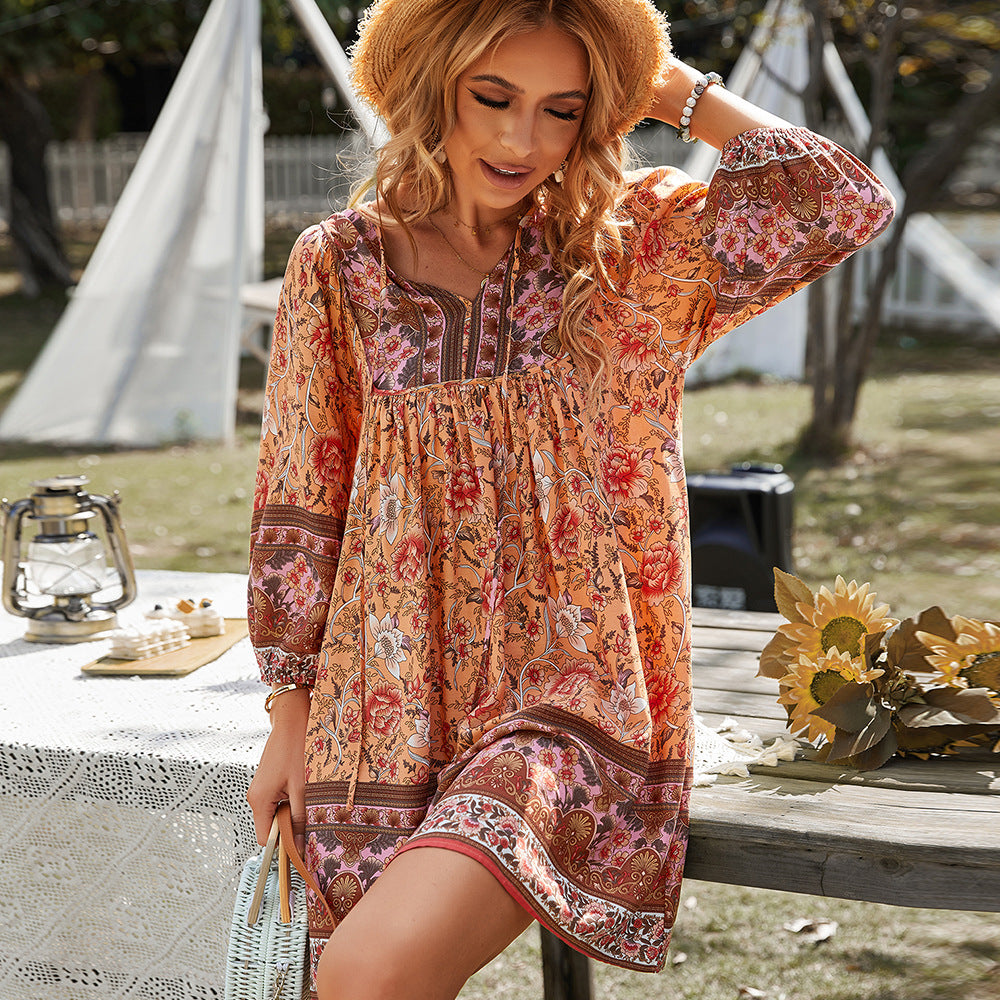 Woman relaxing outdoors in the Penelope boho tunic dress with a vivid floral print.