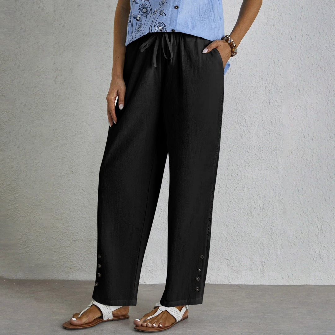 Woman wearing relaxed button-detail trousers with a simple top, out for the day.