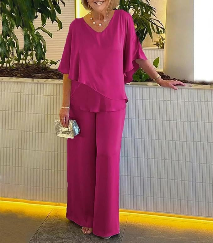 A woman wearing an asymmetric flowing top with matching wide-leg trousers.