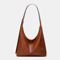 Oversized plain black crossbody bag with a wide shoulder strap