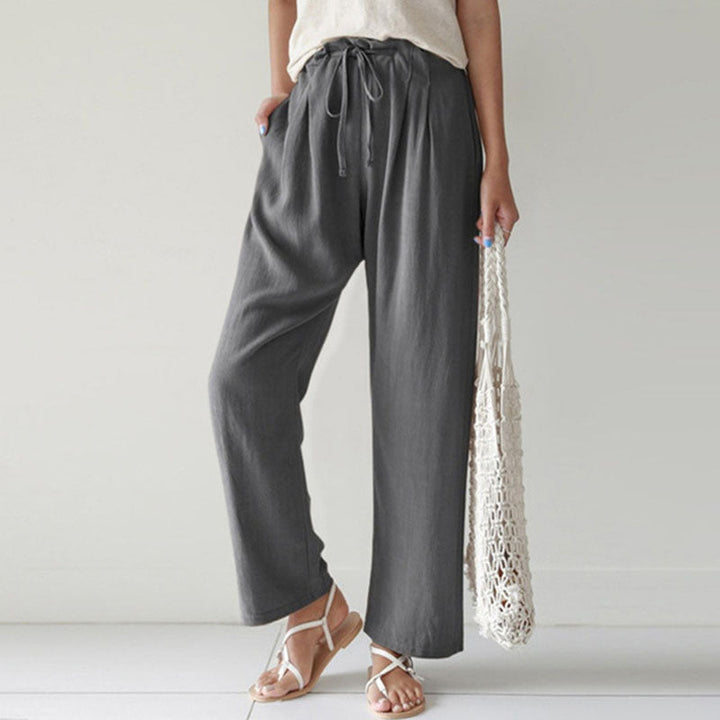 A woman walking outdoors in relaxed drawstring trousers with an easy, comfortable everyday look.