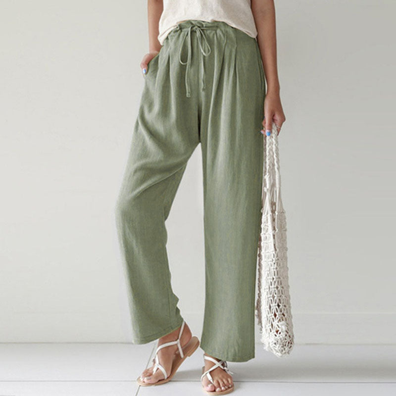 A woman walking outdoors in relaxed drawstring trousers with an easy, comfortable everyday look.