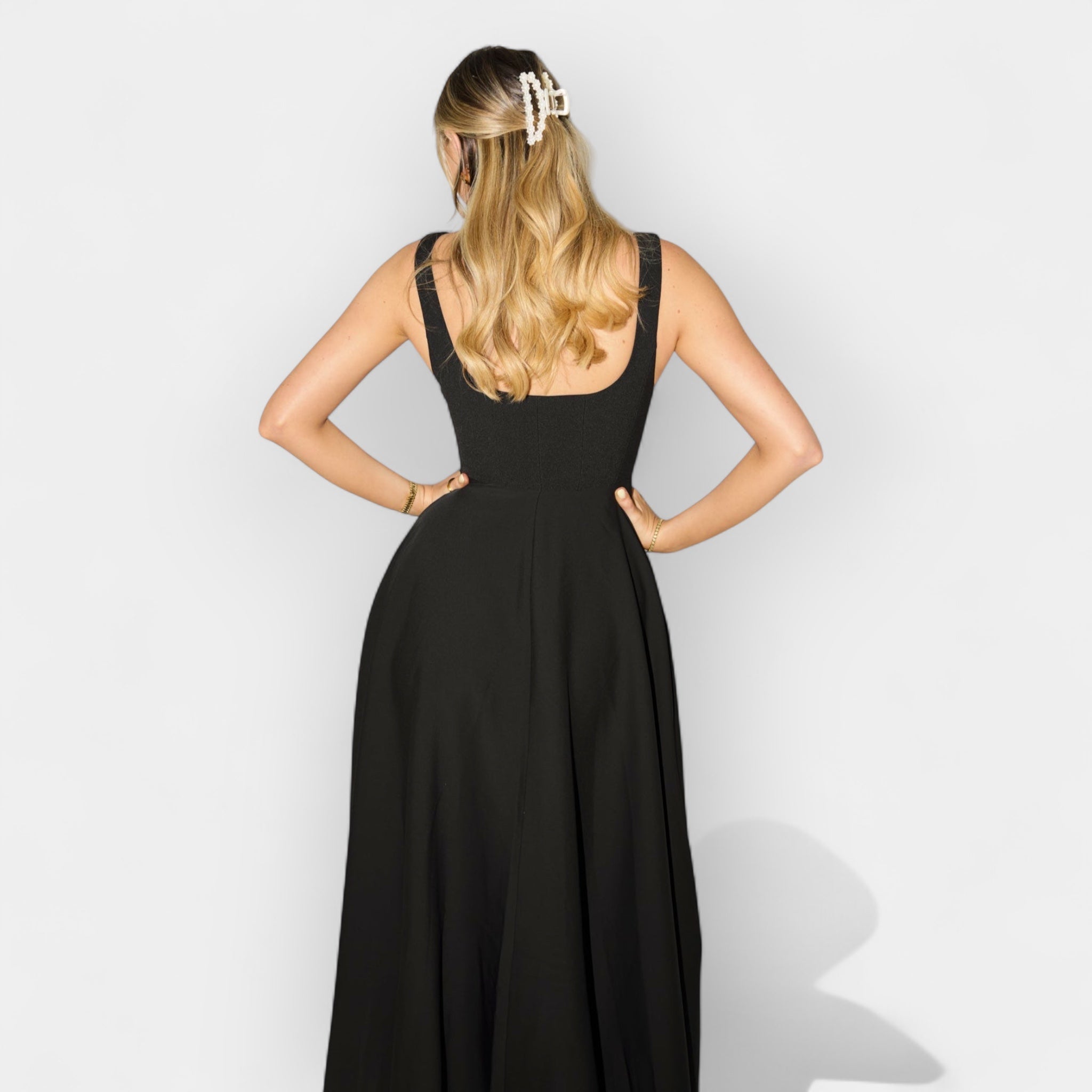 Elegant white midi A-line dress with a square neckline and flowing feminine skirt