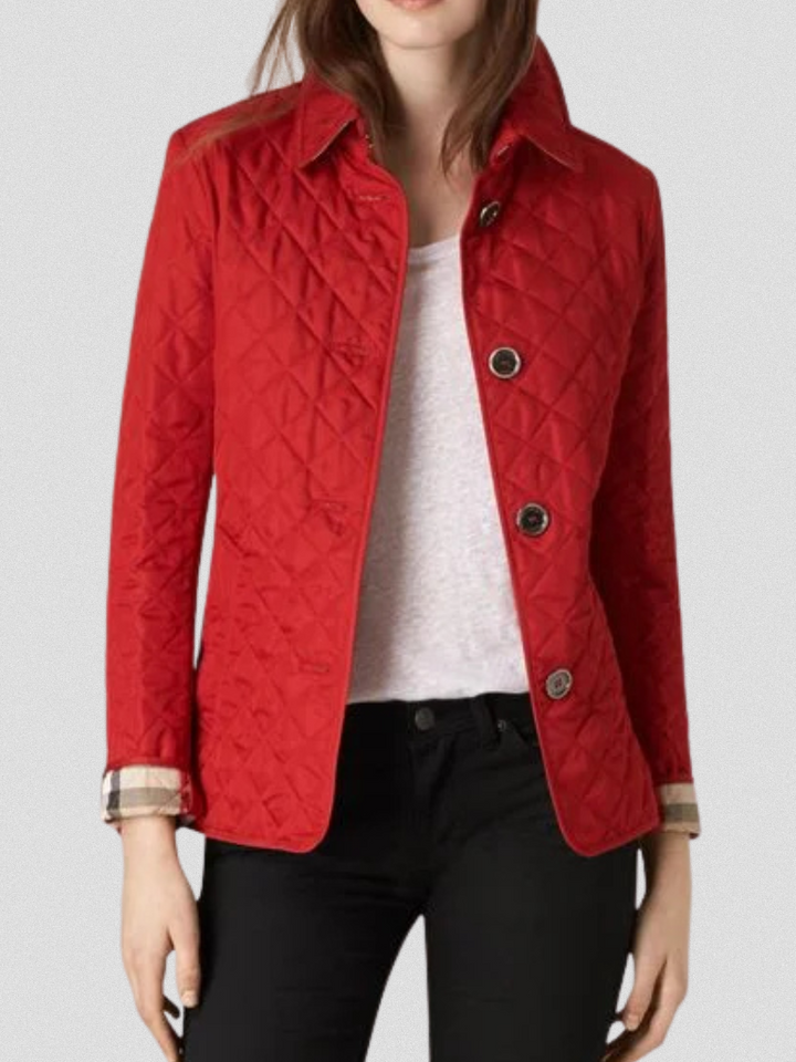 A woman wearing an autumn jacket over a top, layered for a crisp day in town.