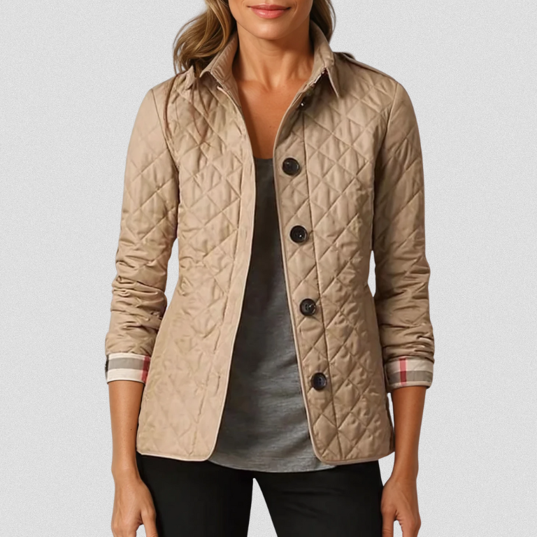 A woman wearing an autumn jacket over a top, layered for a crisp day in town.