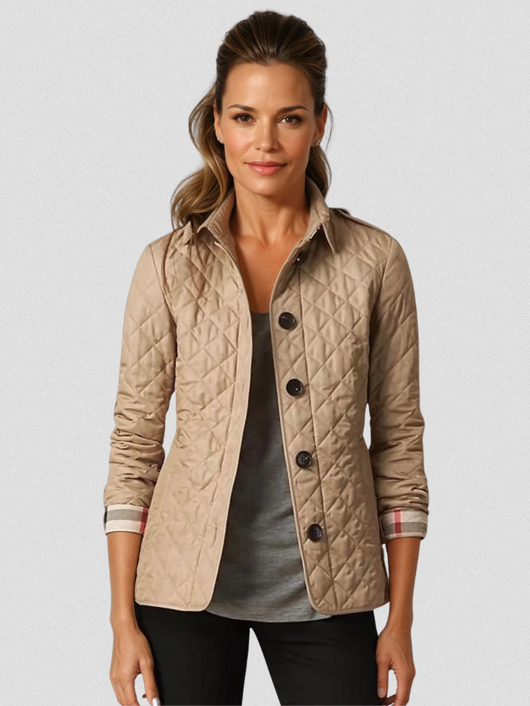 A woman wearing an autumn jacket over a top, layered for a crisp day in town.