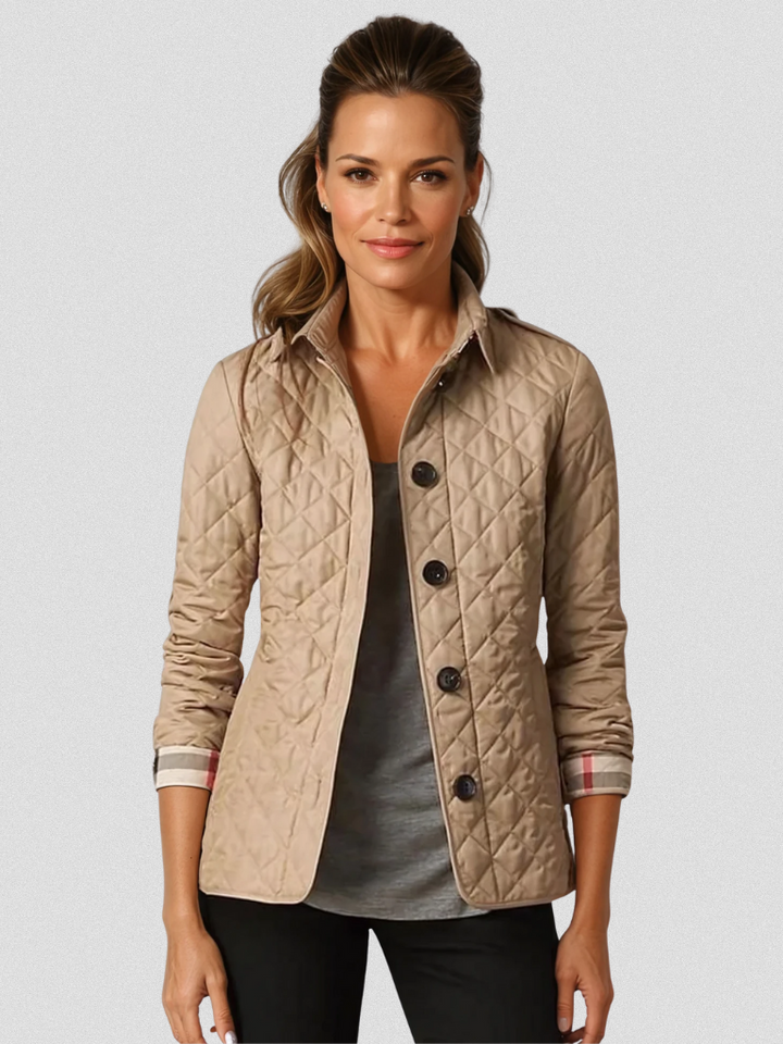 A woman wearing an autumn jacket over a top, layered for a crisp day in town.