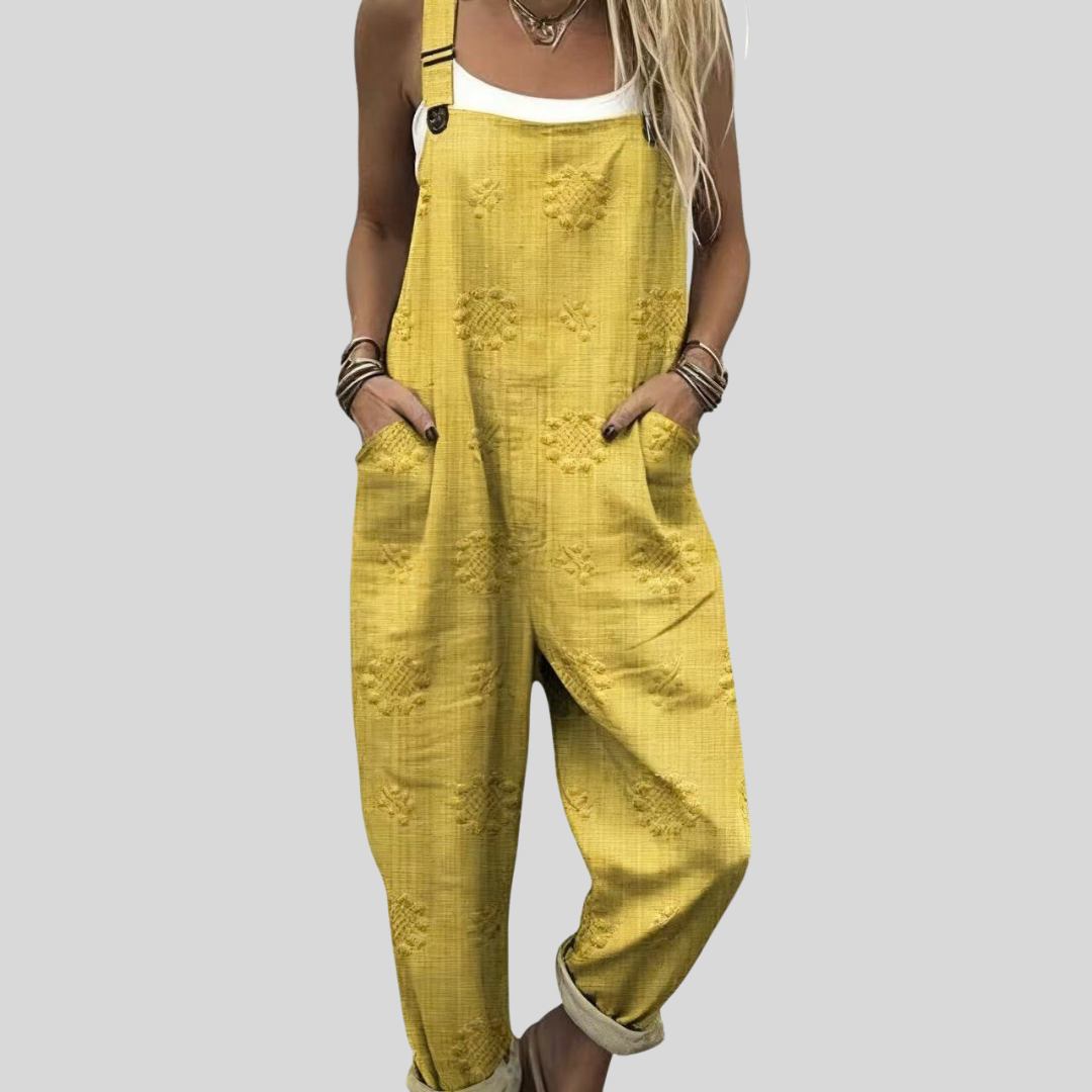 Warm yellow dungarees with a subtle all-over geometric woven texture, adjustable shoulder straps and side pockets.