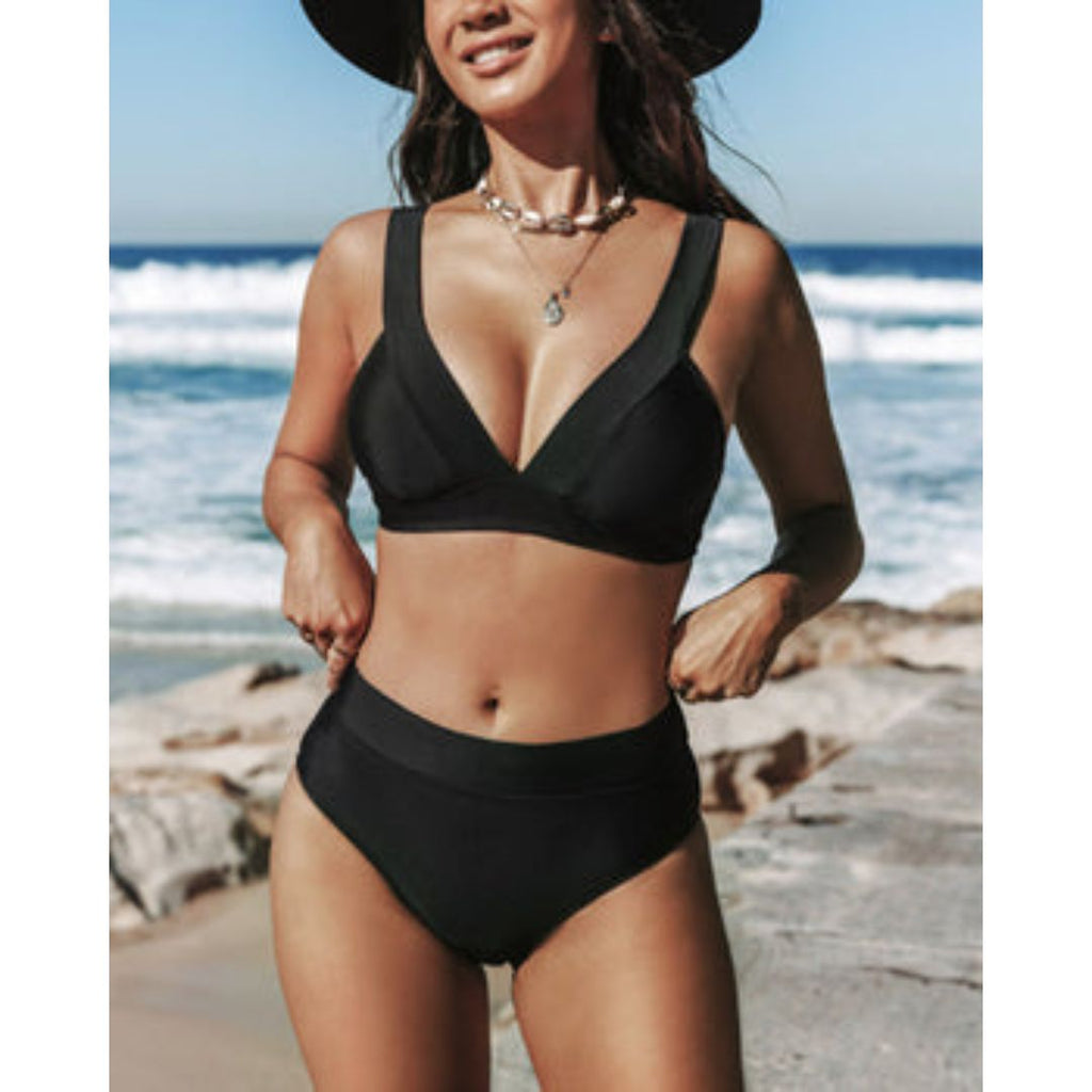 High-leg one-piece swimsuit with V neckline in black, displayed on a model