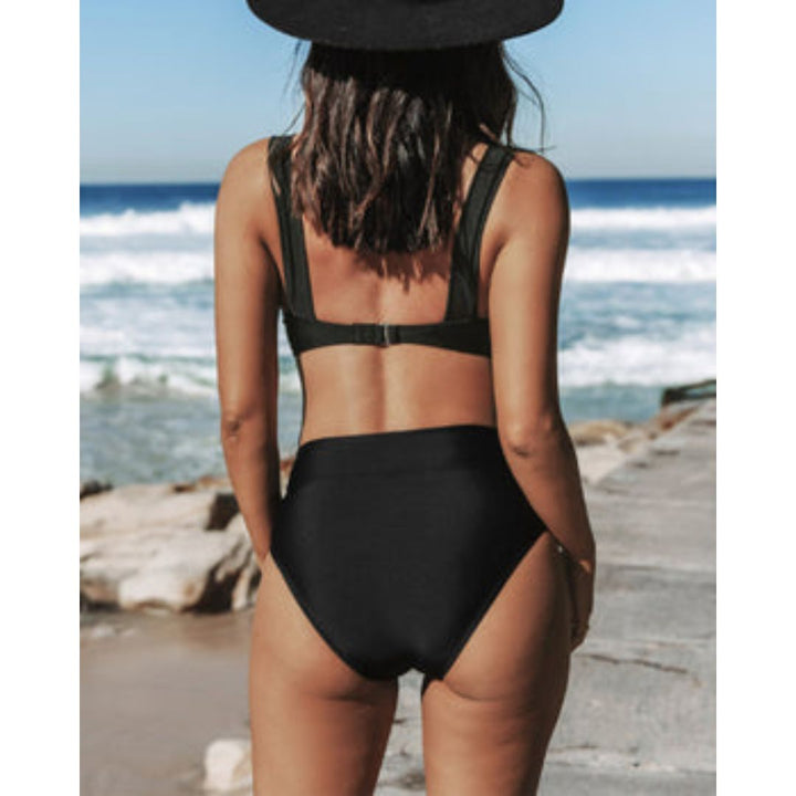 High-leg one-piece swimsuit with V neckline in black, displayed on a model