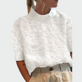 White women's high-neck blouse with raised embossed floral texture and short sleeves