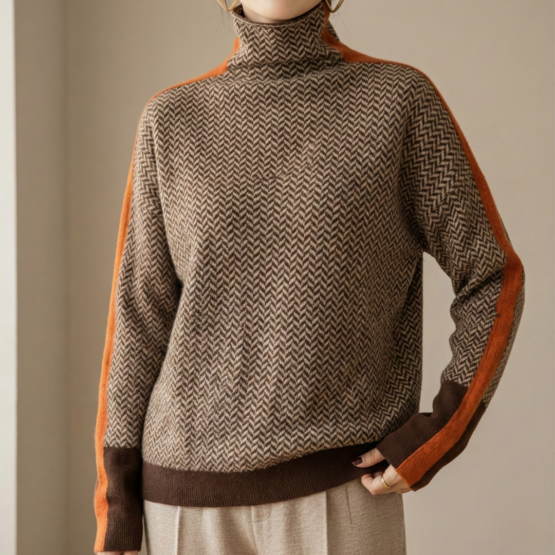 A woman wearing a brown and beige chevron high-collar jumper with bright green side stripes.
