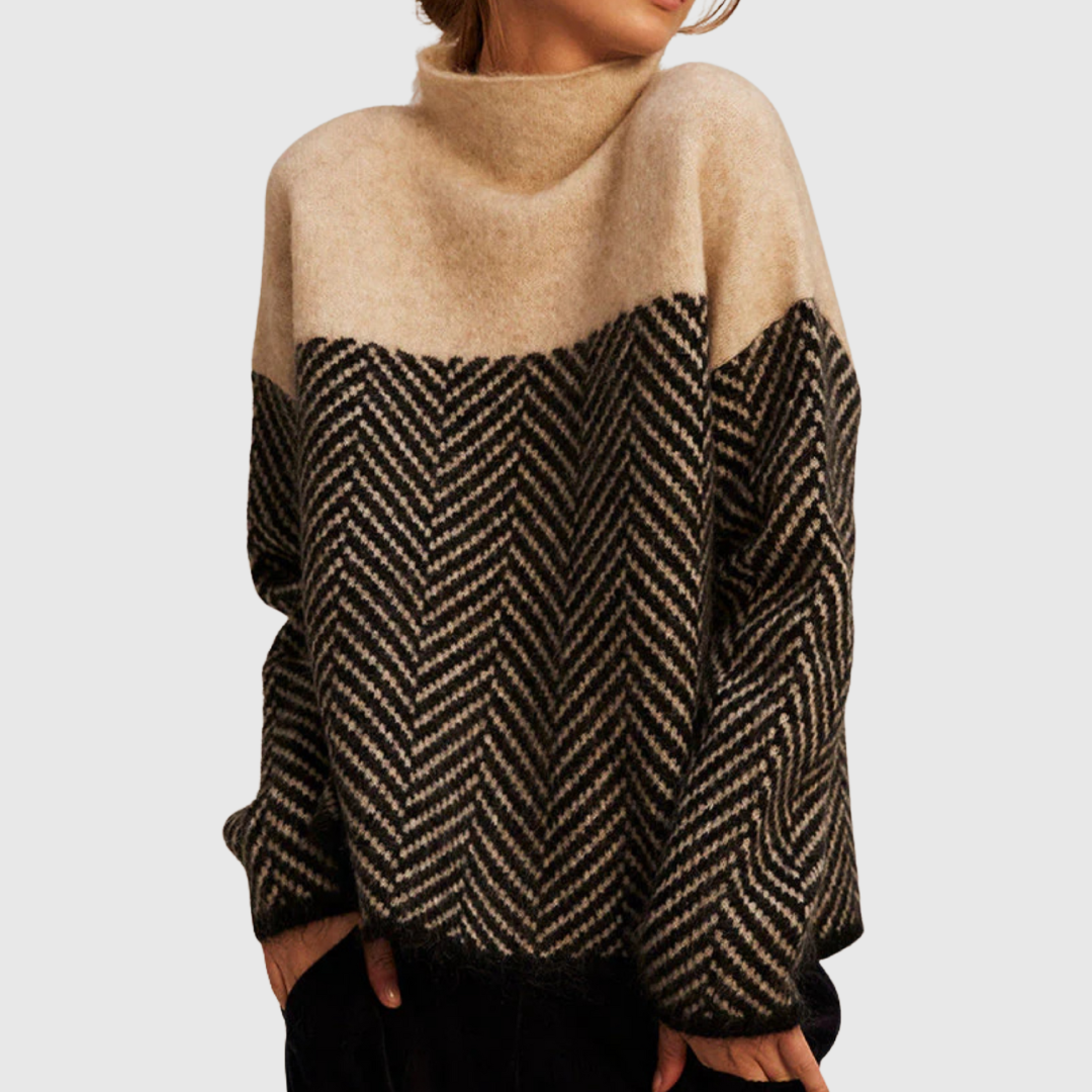 A woman wearing a zigzag-pattern funnel neck jumper styled elegantly for an autumn day out.